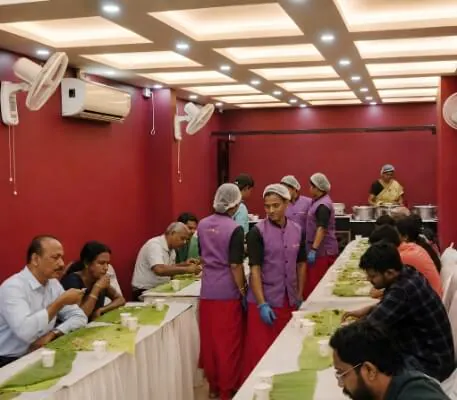 Guests being served by the Hotel CAPS catering team at an event
