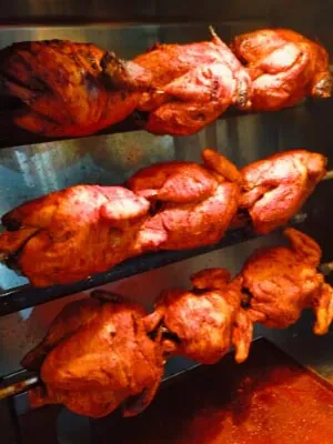 Tandoori-style grilled chicken pieces fresh from the grill