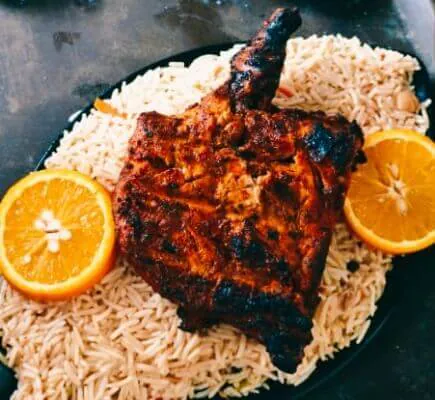Spicy grilled fish served with aromatic rice and lemon