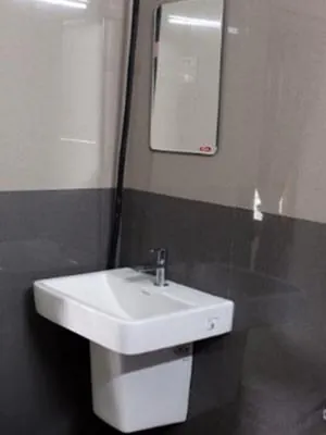Wash basin and mirror in a Hotel CAPS room bathroom