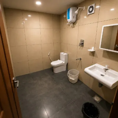 Spacious Hotel CAPS bathroom with shower, toilet, wash basin and mirror